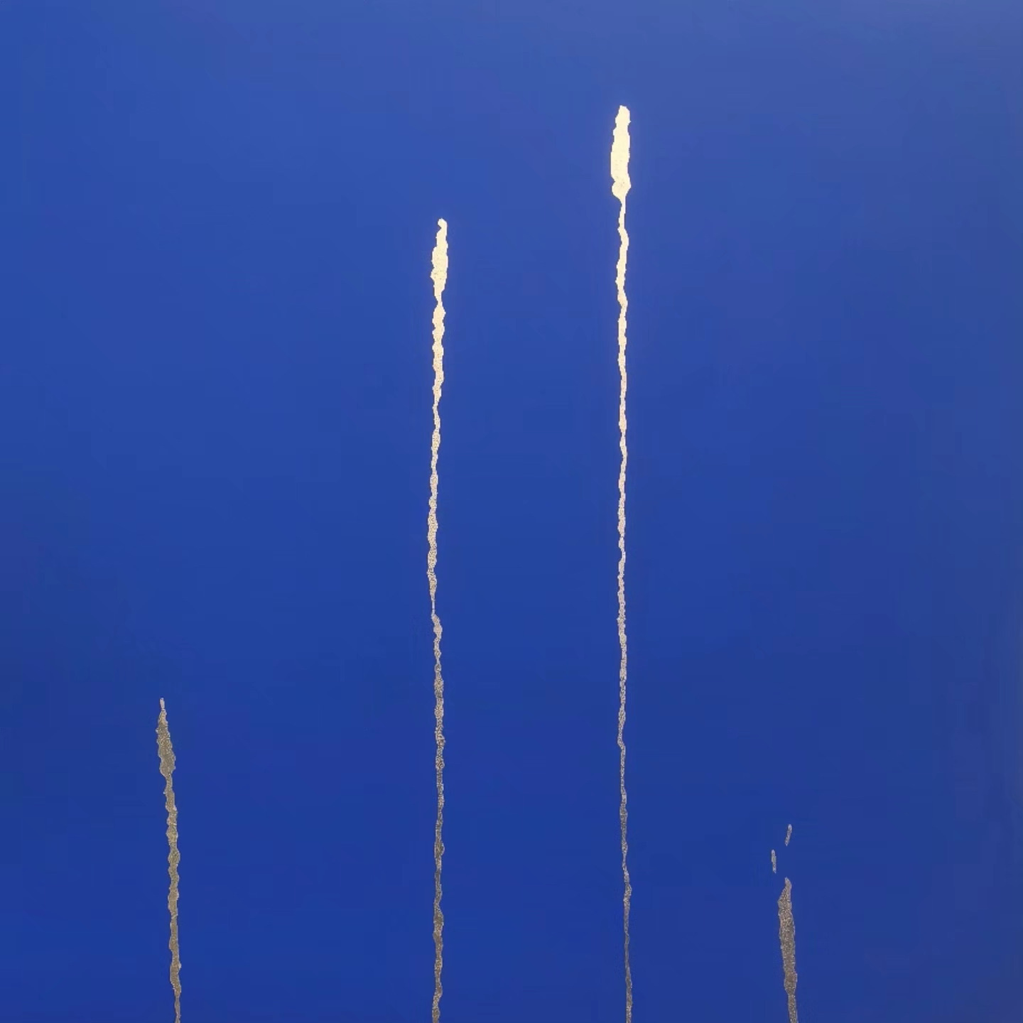 Four ragged vertical lines of gold and cream rising from the lower edge of a deep blue field, each ending in a small flare, like burnt-down tapers of different heights.